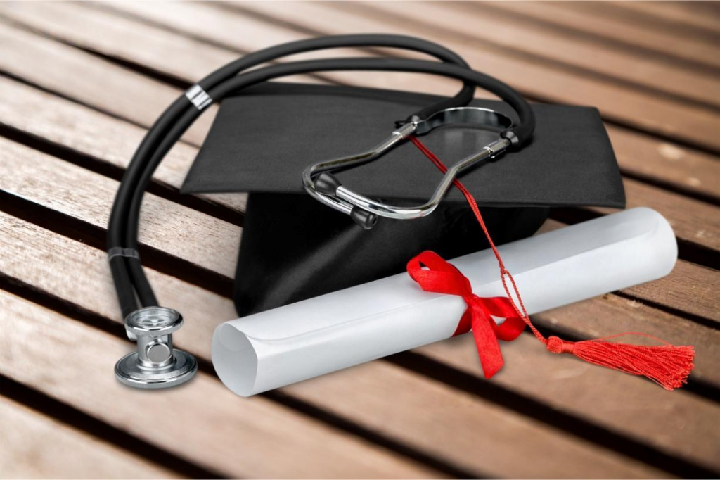 A graduation cap and diploma with a stethoscope

Description automatically generated