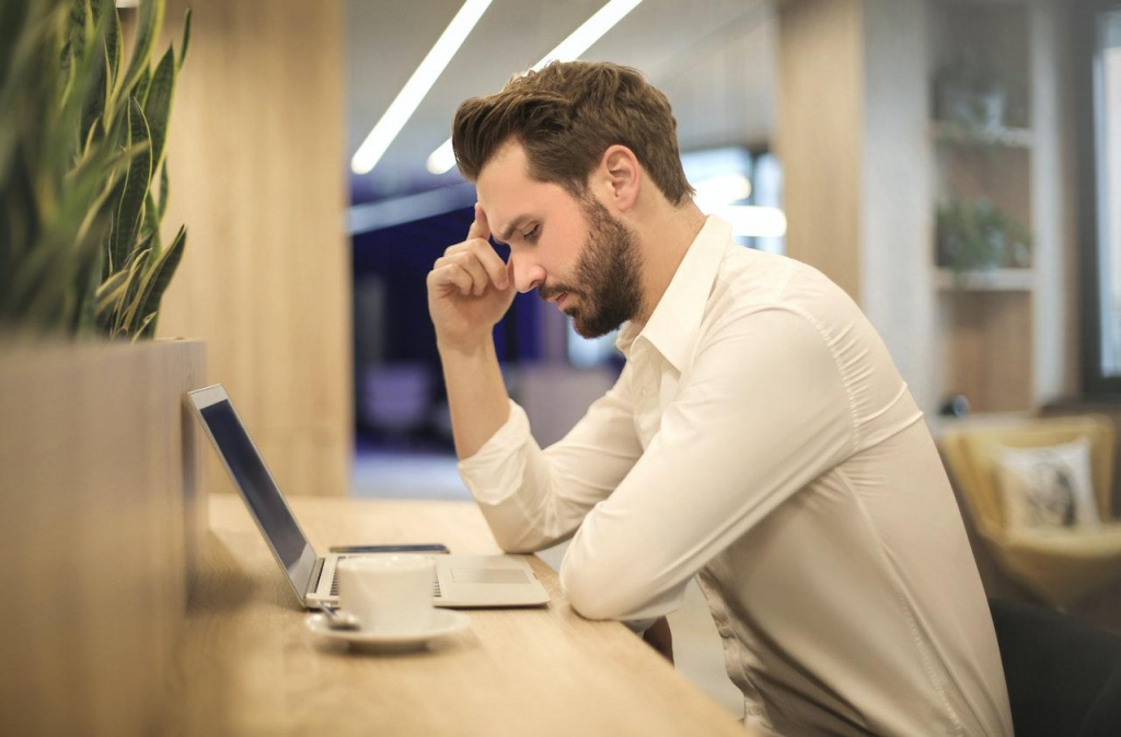 A person sitting at a table with a computer

Description automatically generated with medium confidence